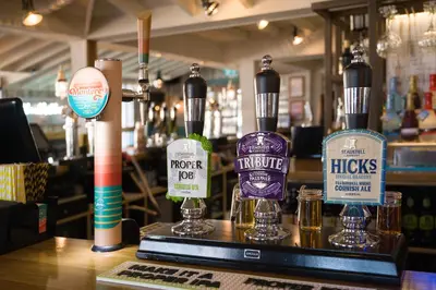 a bar with bottles of alcohol on a counter at Oystercatcher Apartments in Polzeath