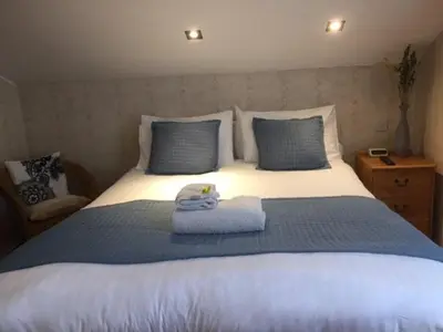 a bedroom with a bed with two towels on it at Poltair Guest House in Falmouth