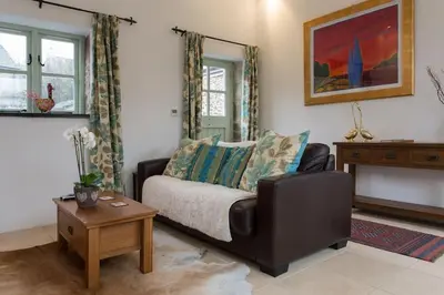 a living room with a couch and a table at The Snuggery in Truro
