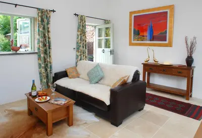 a living room with a couch and a table at The Snuggery in Truro