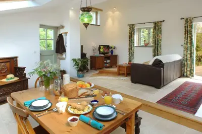 a living room with a table with food on it at The Snuggery in Truro