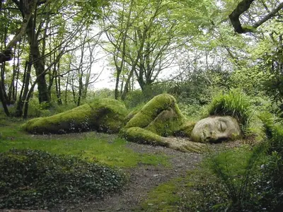 a statue of a woman laying in the grass at The Snuggery in Truro