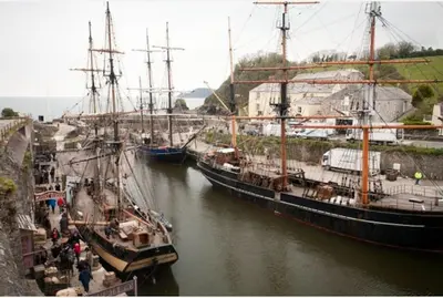 a group of boats docked in a river at The Snuggery in Truro