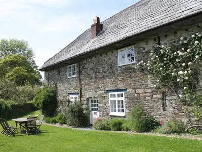 an old stone house with a table and chairs at Harry in Bodmin