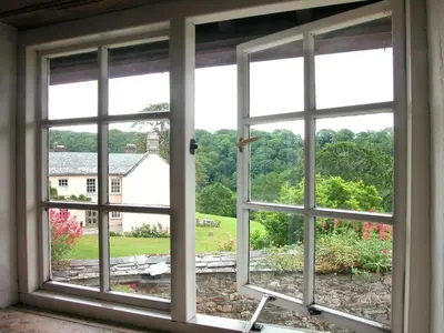 an open window with a view of a yard at Tom in Bodmin