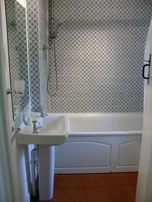 a bathroom with a sink and a bath tub at Dick Cottage in Bodmin