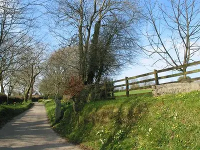 a path in a field next to a fence at Higher Tumrose in Blisland