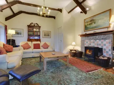 a living room with a couch and a fireplace at Higher Tumrose in Blisland