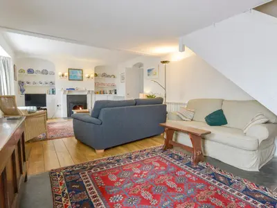 a living room with a couch and a table at Agar Cottage in Port Isaac