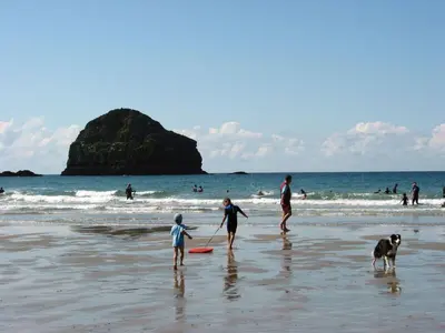 a group of people on the beach with a dog at Heightley House in Tintagel