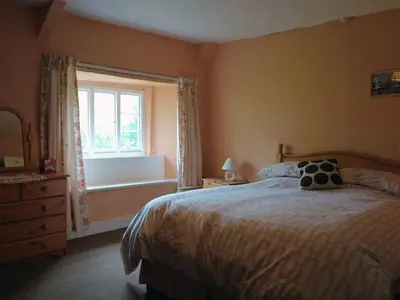 a bedroom with a bed and a window at Tresungers Cottage in Port Isaac