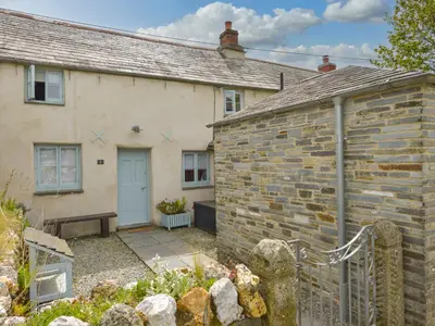a brick house with a garden in front of it at 3 Newhall Green in Delabole