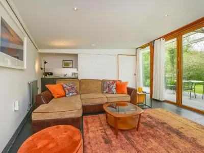 a living room with a couch and a table at 3 Newhall Green in Delabole