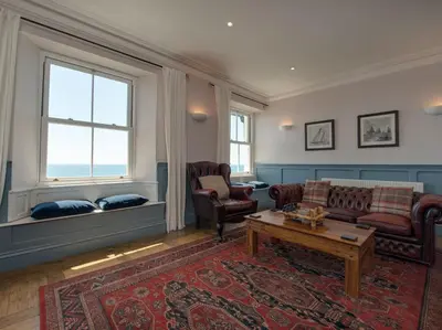 a living room with a couch and a coffee table at The Captains House in Downderry