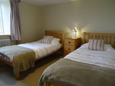 a bedroom with two beds and a window at Kingbarth in Lerryn