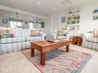 a living room with couches and a coffee table at Pier Cottage in Saint Mawes