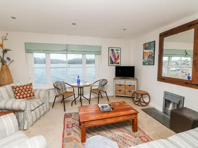 a living room with a table and a couch at Pier Cottage in Saint Mawes
