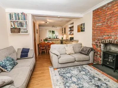 a living room with a couch and a fireplace at Quarry Cottage in Flushing
