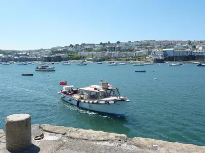 a boat in a body of water with boats at Quarry Cottage in Flushing