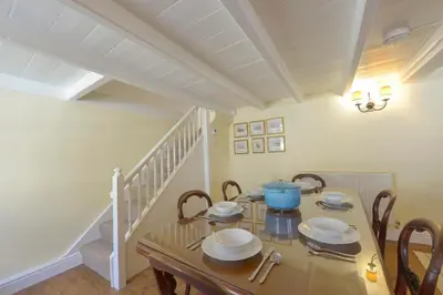 a dining room with a table and chairs at April Cottage in Coverack