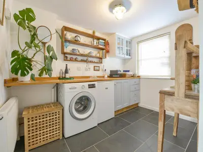 a laundry room with a washer and dryer at 2 Trerise Cottage in Helford