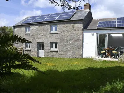 a house with solar panels on the roof at The Studio in Germoe