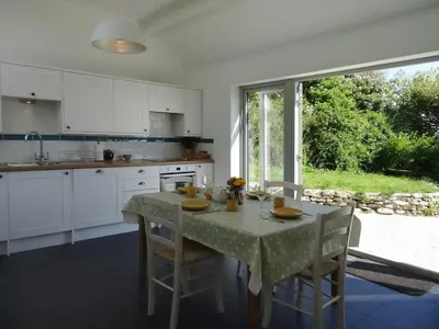 a kitchen with a table with a tablecloth on it at The Studio in Germoe