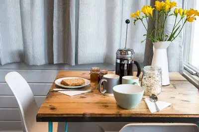 a wooden table with food and flowers on it at The cabin in Truro