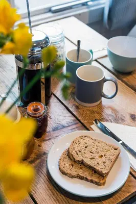 a slice of bread on a plate on a table at The cabin in Truro
