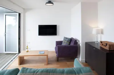 a living room with a couch and a chair at Falmouth Self Catering Lodges in Falmouth
