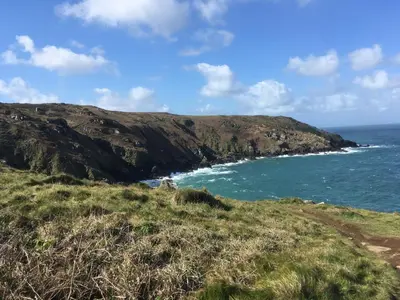 a view of the ocean from a hill with a beach at Storm in a tea cup in St Ives