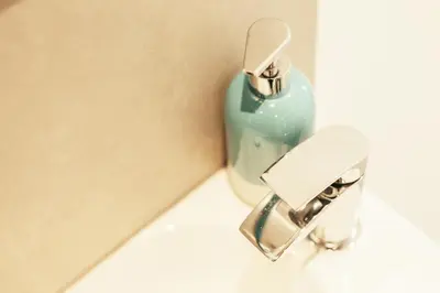 a bathroom sink with a soap dispenser on a counter at Storm in a tea cup in St Ives