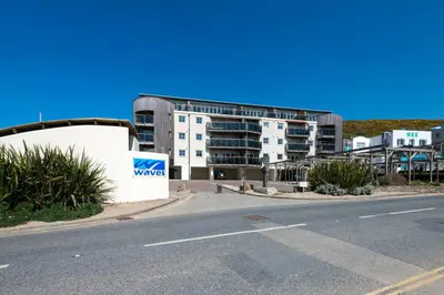 an empty street in front of a building at Waves Apartments in Newquay