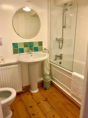 a bathroom with a sink and a shower and a toilet at Cyntwell Guest Accommodation in Padstow