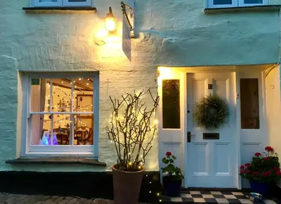 a white house with a white door and a window at Cyntwell Guest Accommodation in Padstow