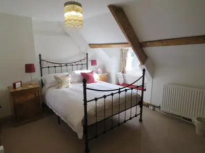 a bedroom with a large bed in a attic at Cyntwell Guest Accommodation in Padstow