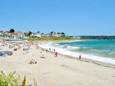a group of people on a beach near the ocean at Black Thorn Cottage in Falmouth