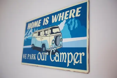 a sign that says home is where the park our camper at Horizons Apartments Newquay in Newquay