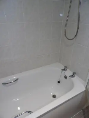 a bathroom with a white tub and a sink at Hengar Select in Saint Tudy