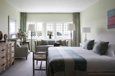 a bedroom with a king sized bed and a couch at Hotel Tresanton in Saint Mawes