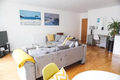 a living room with a couch and a table at SeaQuest 1 in Newquay