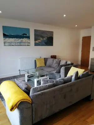 a living room with a couch and a table at SeaQuest 1 in Newquay