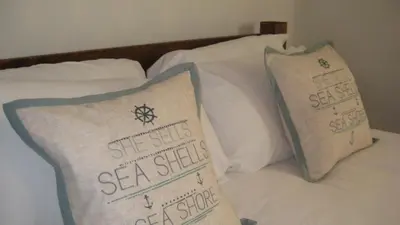 a bed with two pillows on top of it at SeaQuest 1 in Newquay