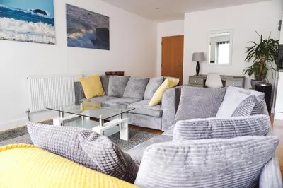 a living room with a couch and a table at SeaQuest 1 in Newquay