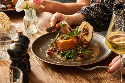 a plate of food on a wooden table with a plate of food at Havener's in Fowey