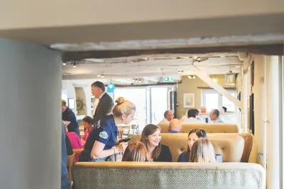 a group of people sitting on a bus at Havener's in Fowey
