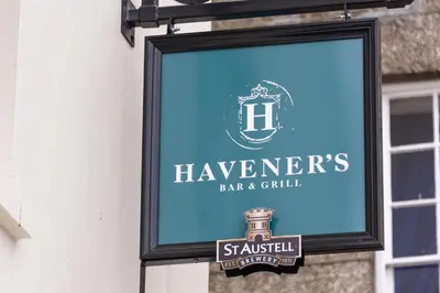 a sign for a bar and grill on the side of a building at Havener's in Fowey