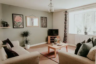a living room with two couches and a coffee table at Higher Trewithen in Stithians