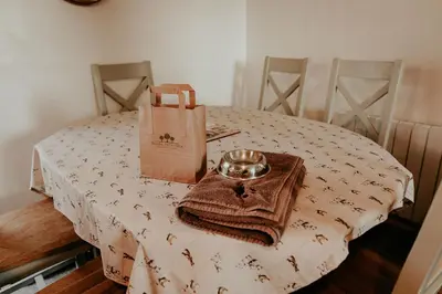 a table with a plate and a bag on it at Higher Trewithen in Stithians
