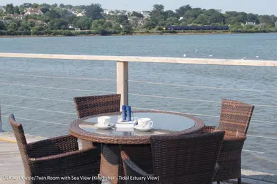 a table and chairs on the deck of a boat at The Old Quay House in Hayle